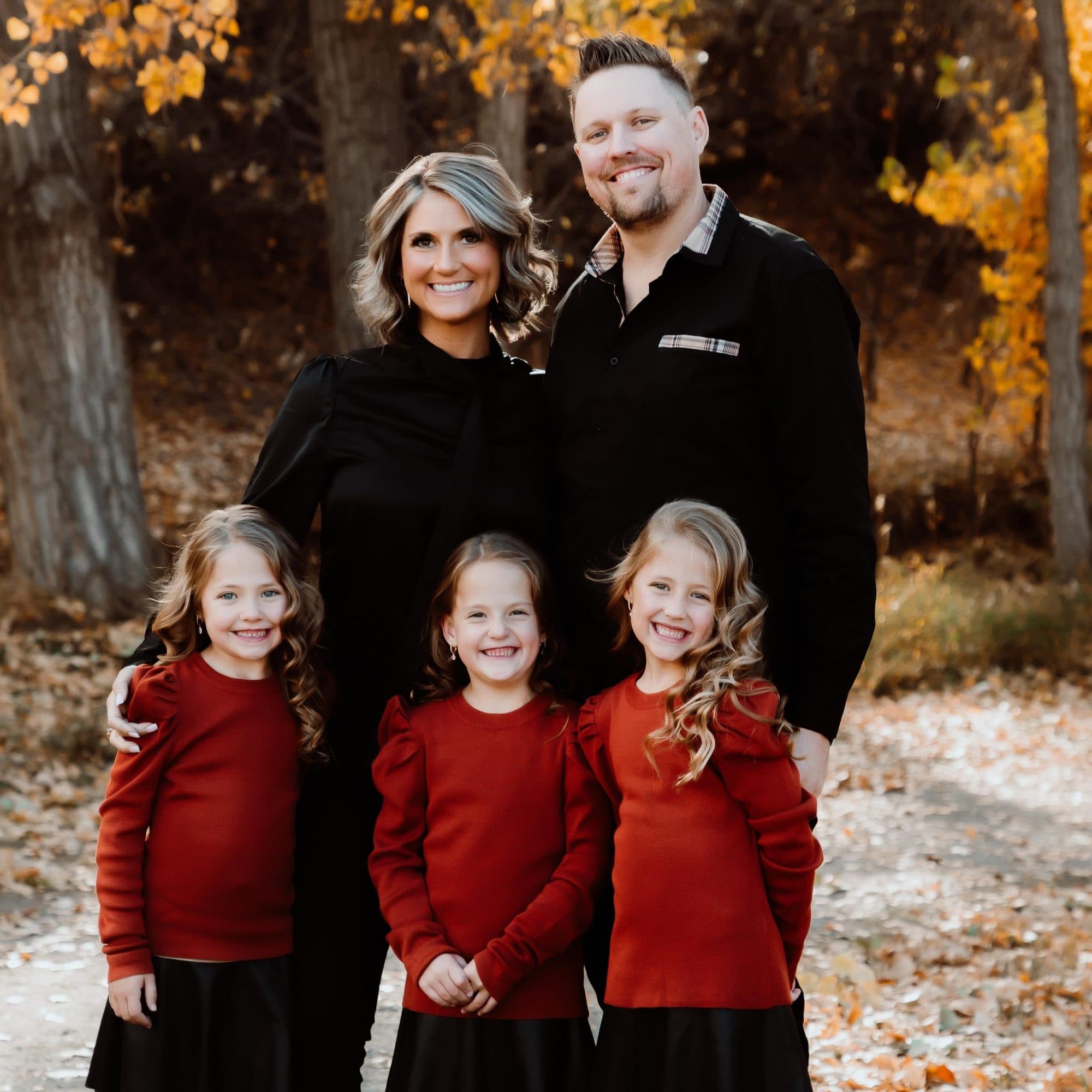 Brock and Brittany Hopfenspirger with their triplet daughters