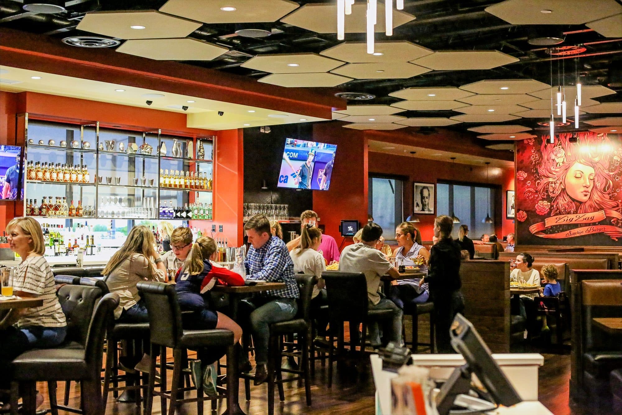 Guests at the bar and booths inside Zig Zag Smokin' Burger